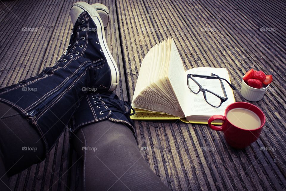 Reading on wooden decking 