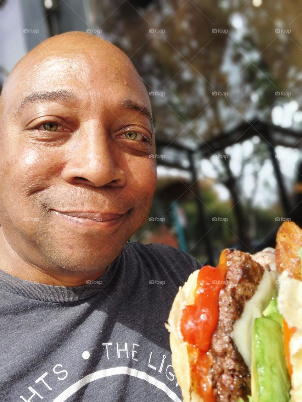 Enjoying a bite of a delicious avocado bacon Burger at a downtown restaurant in Sacramento California