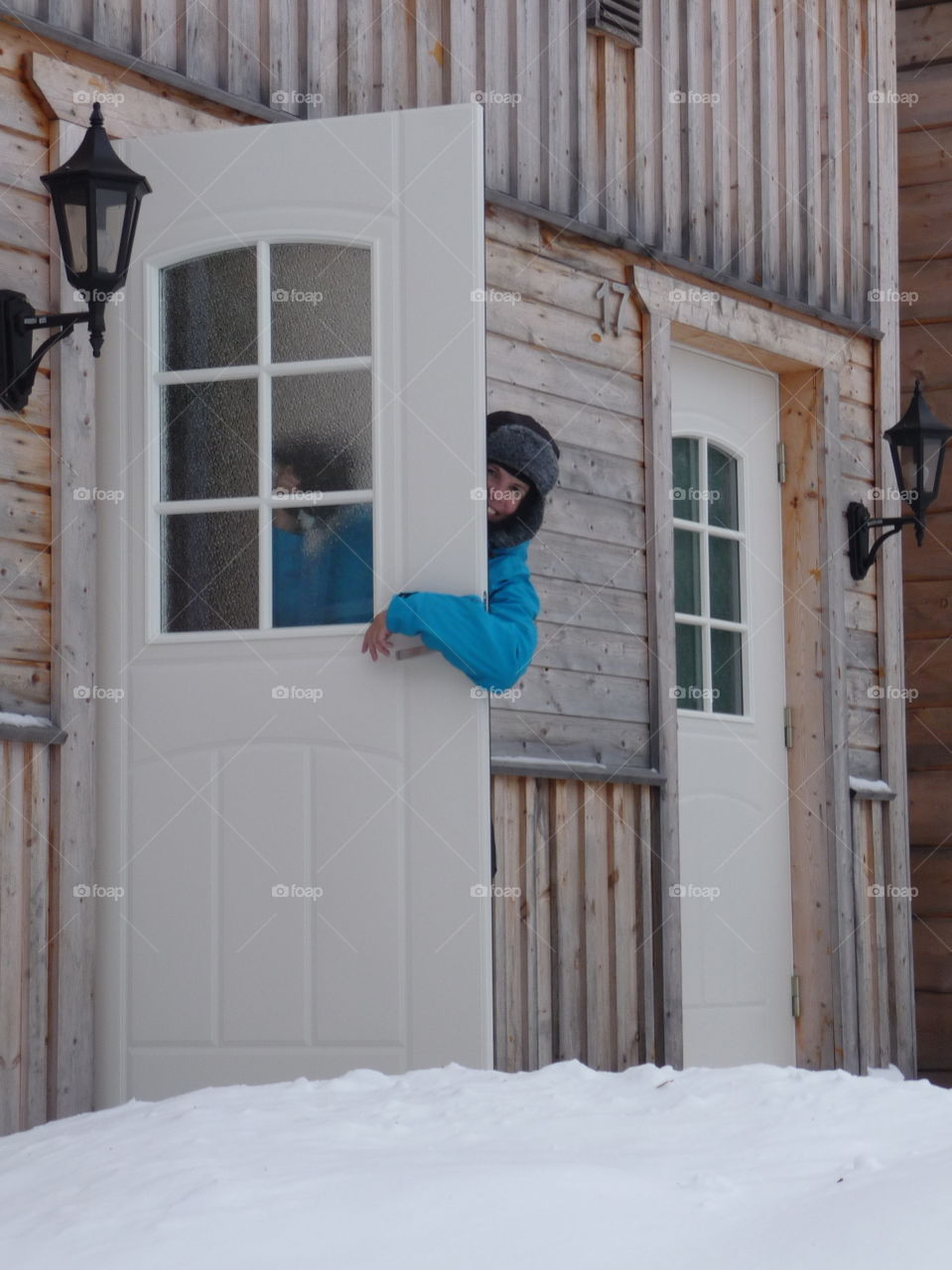 Happy woman standing near door in winter