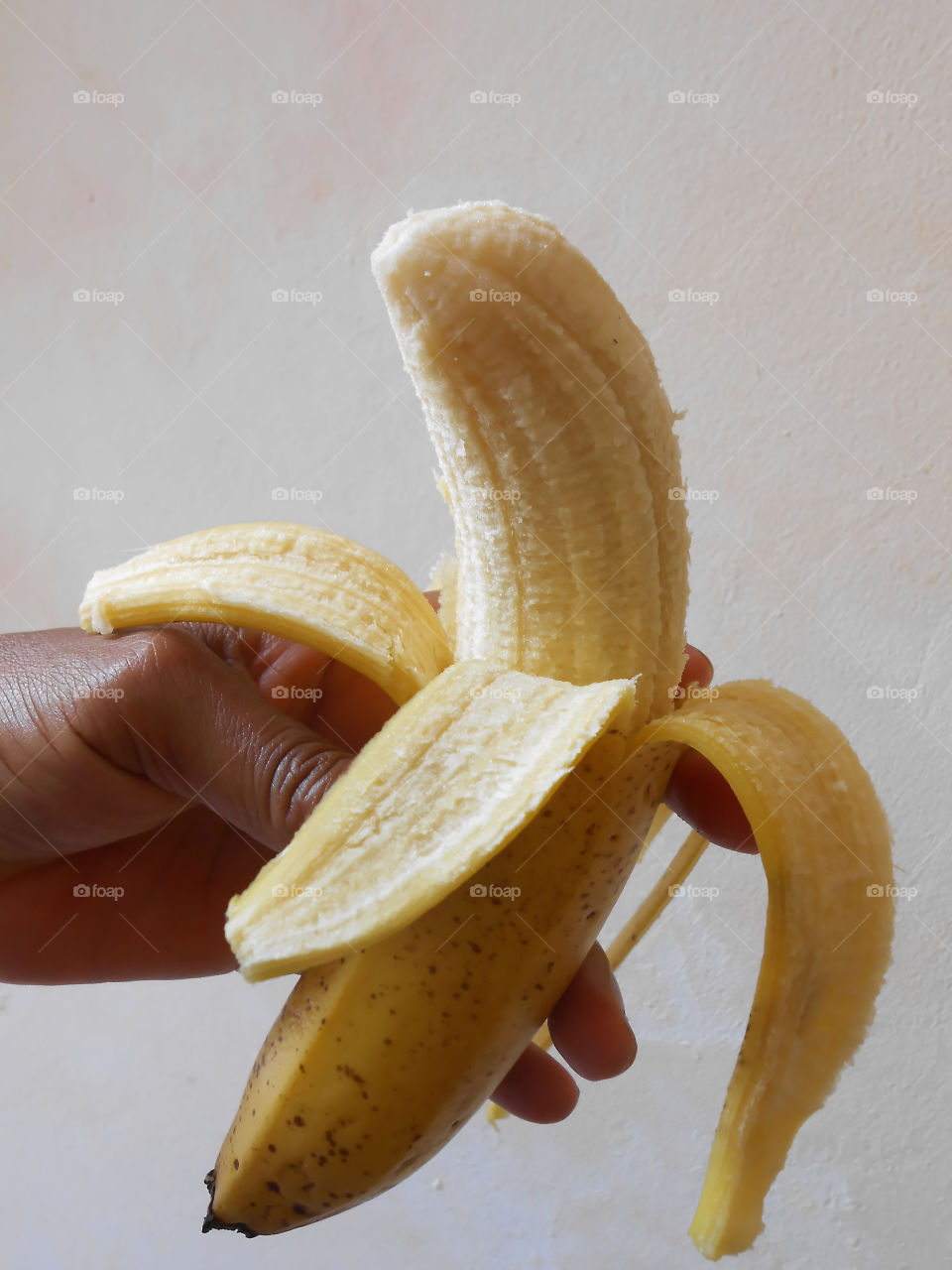 Holding Pealed Ripe Banana