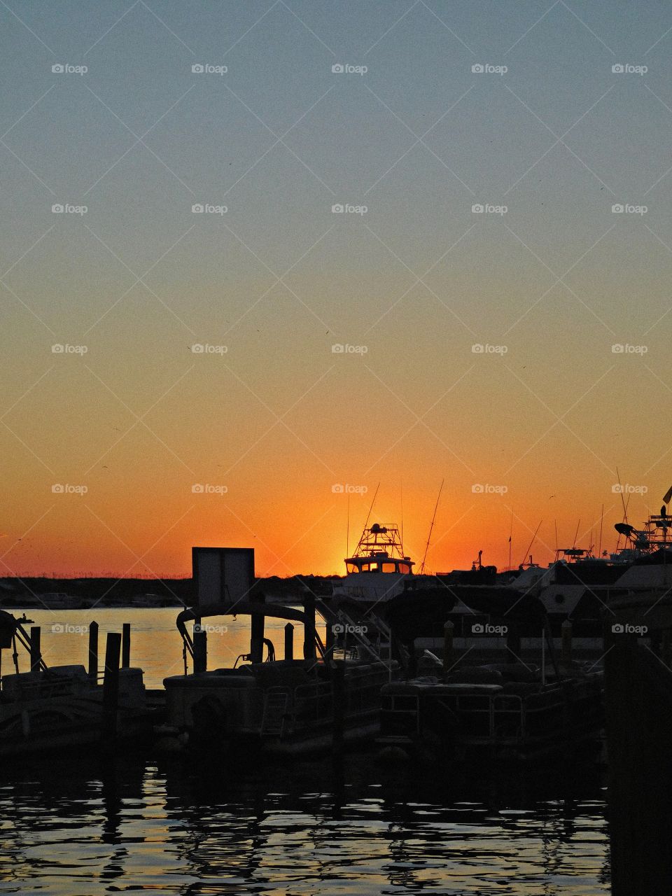 Fishing vessels at sunset - The big orange ball slowly going down and down and it sets into the horizon making the sky absolutely stunning. 