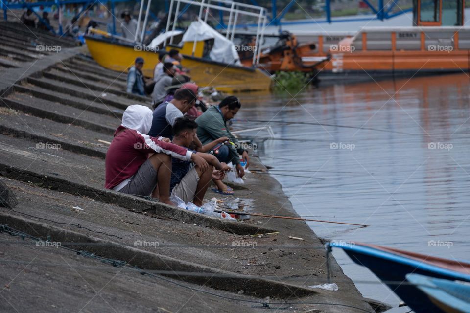 fishing together on the edge of the reservoir