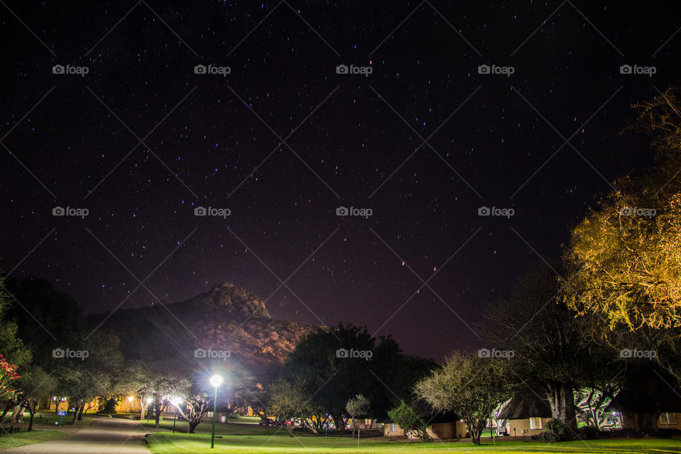 night shot of a resort with a mountain in the back