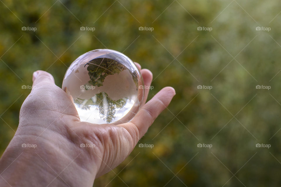 transparent globe in hand