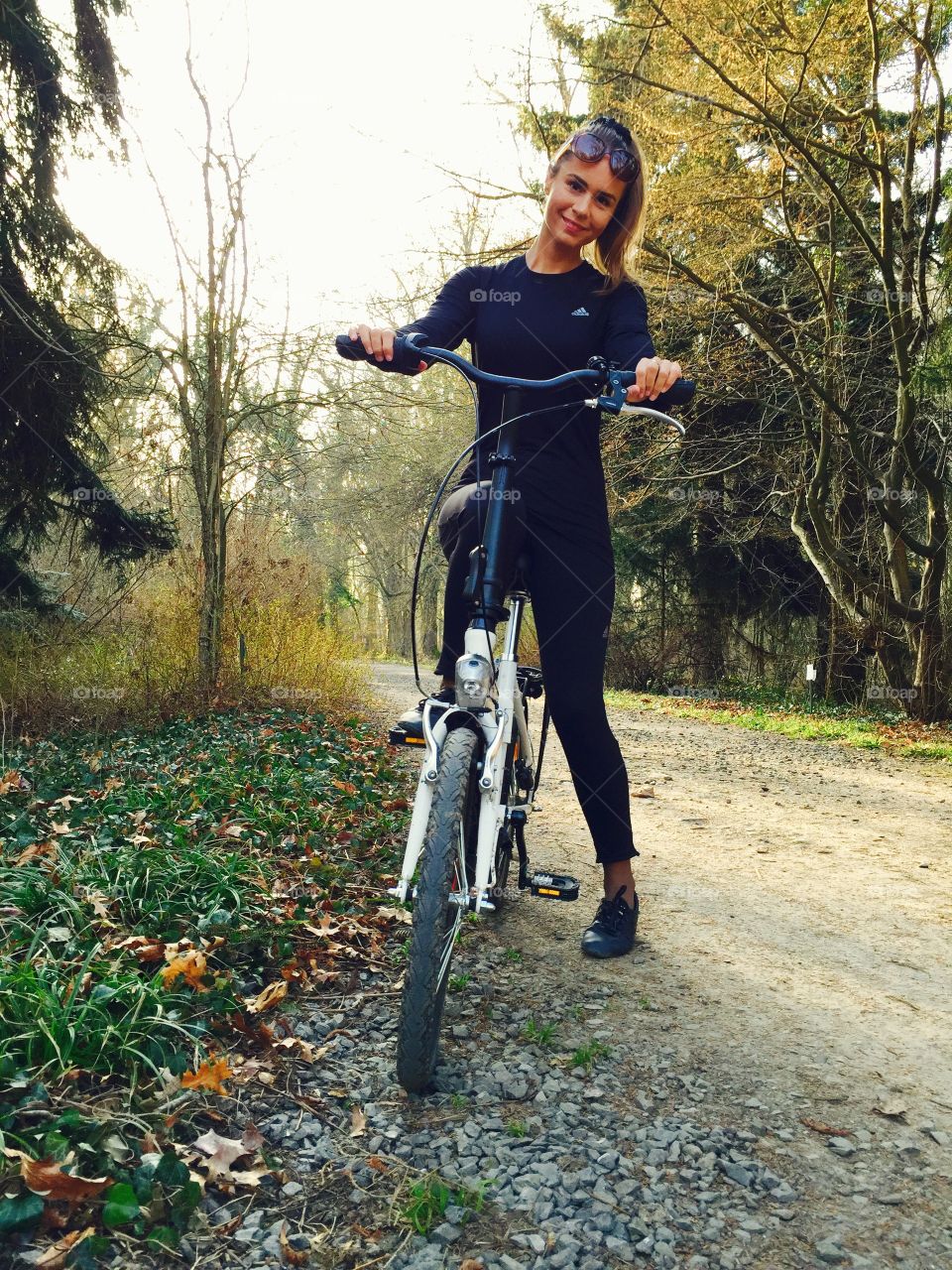 Happy woman cycling on the road