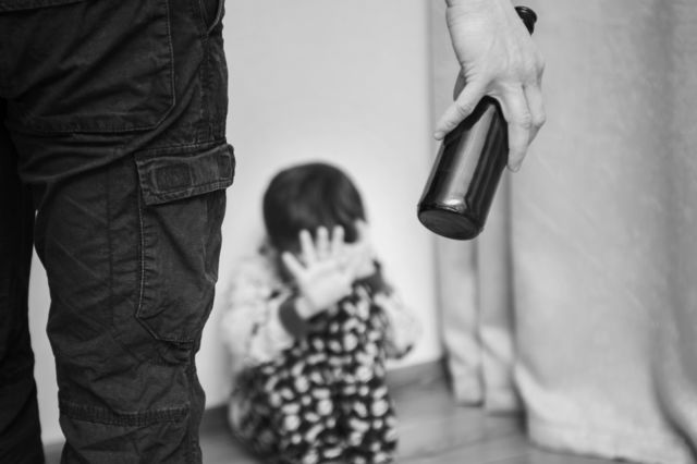 Drunk parent and little scared son. Violence against children concept. Aggression in the family. Alcohol abuse. Domestic violence
