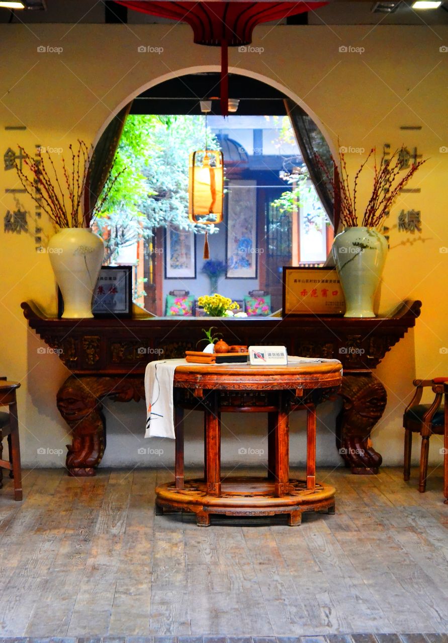 Chengdu Style. A window with a view to a beautiful courtyard garden in Chengdu,Sichuan.