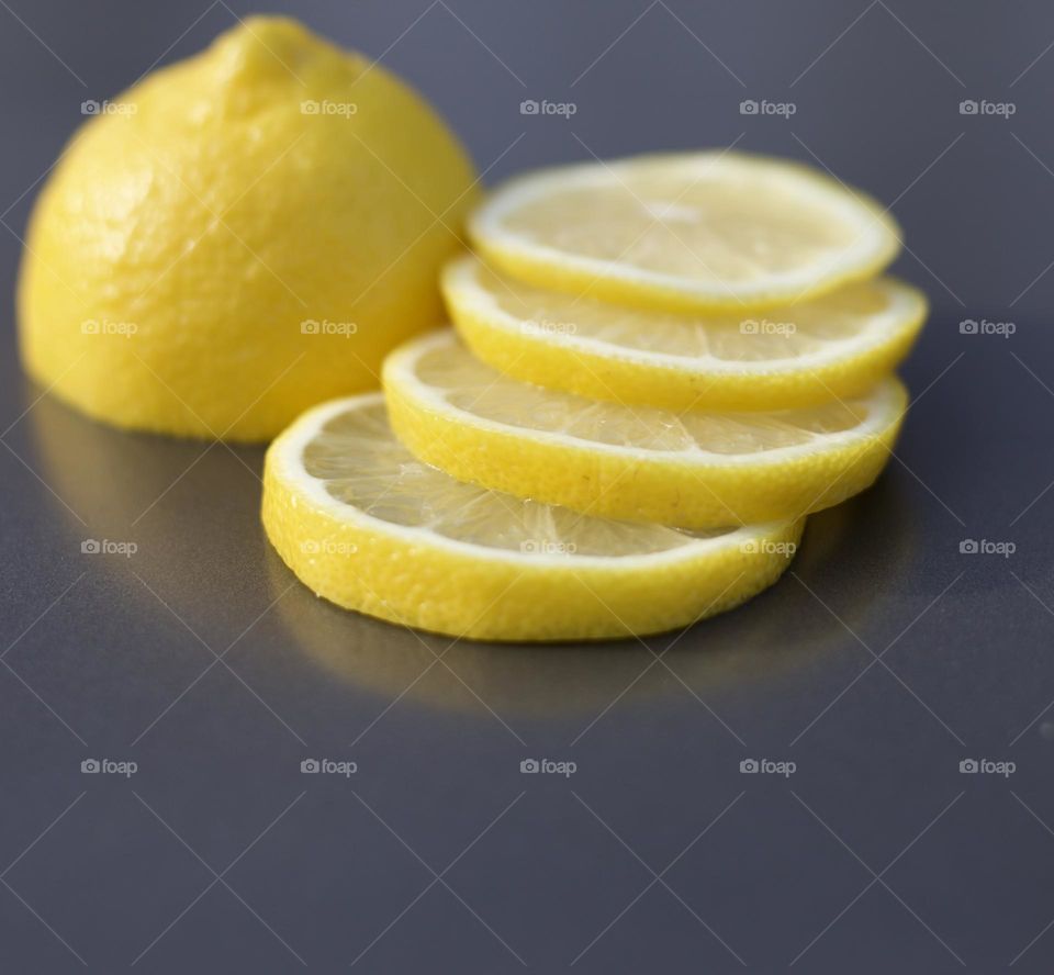 Freshly Illuminating; Half lemon and “staircased” lemon slices on a grey tray