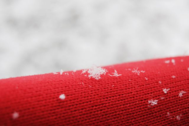 Snowflake on red woolen in winter