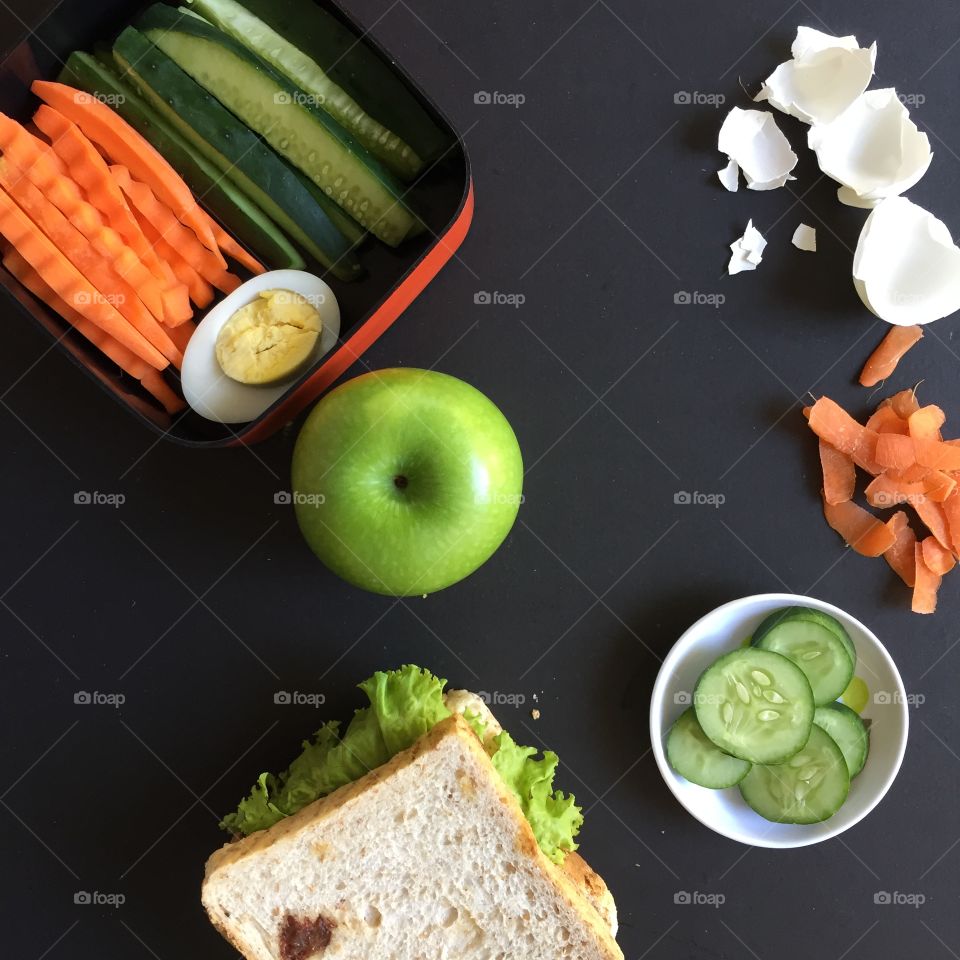 Lunchbox with carrots egg cucumber and apple 