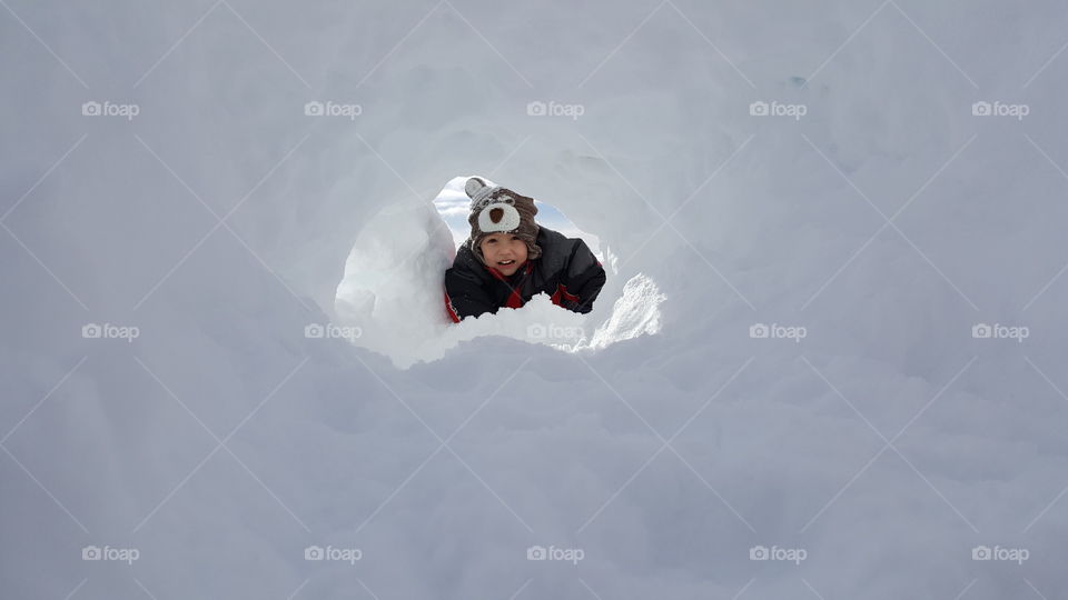 Little girl lying on snowy landscape
