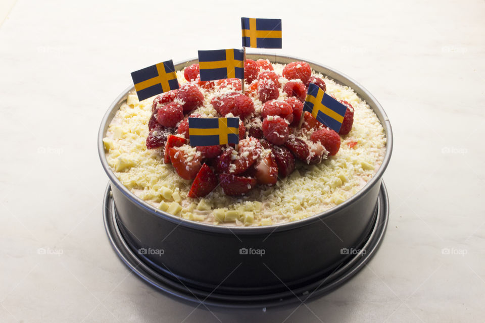 Raspberry strawberry cheesecake with Swedish flags, midsummer cake 