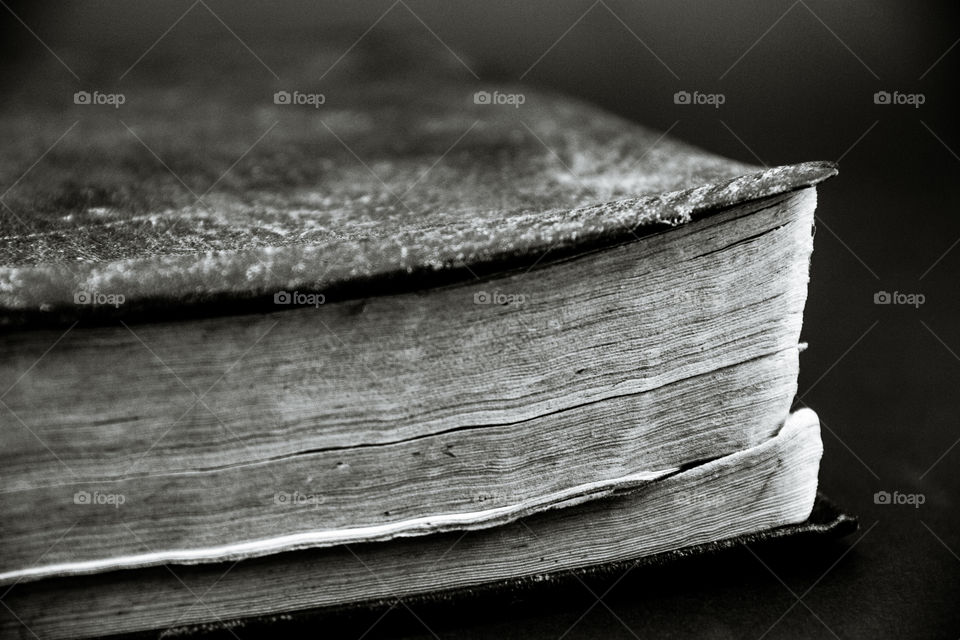 Picture of an old and dusty book with a black background.