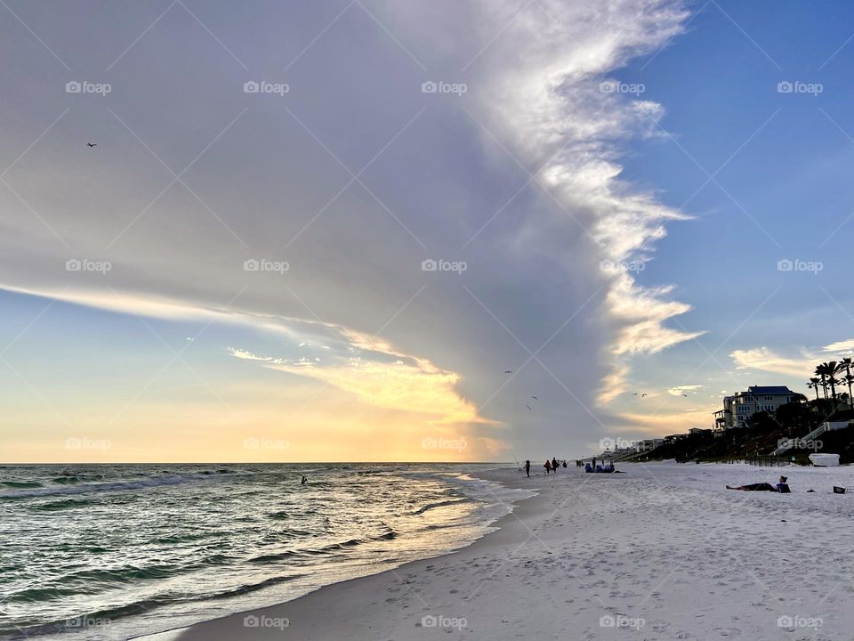 Bands of clouds from tropical storm creating a dramatic sunset scene over the Gulf of Mexico 