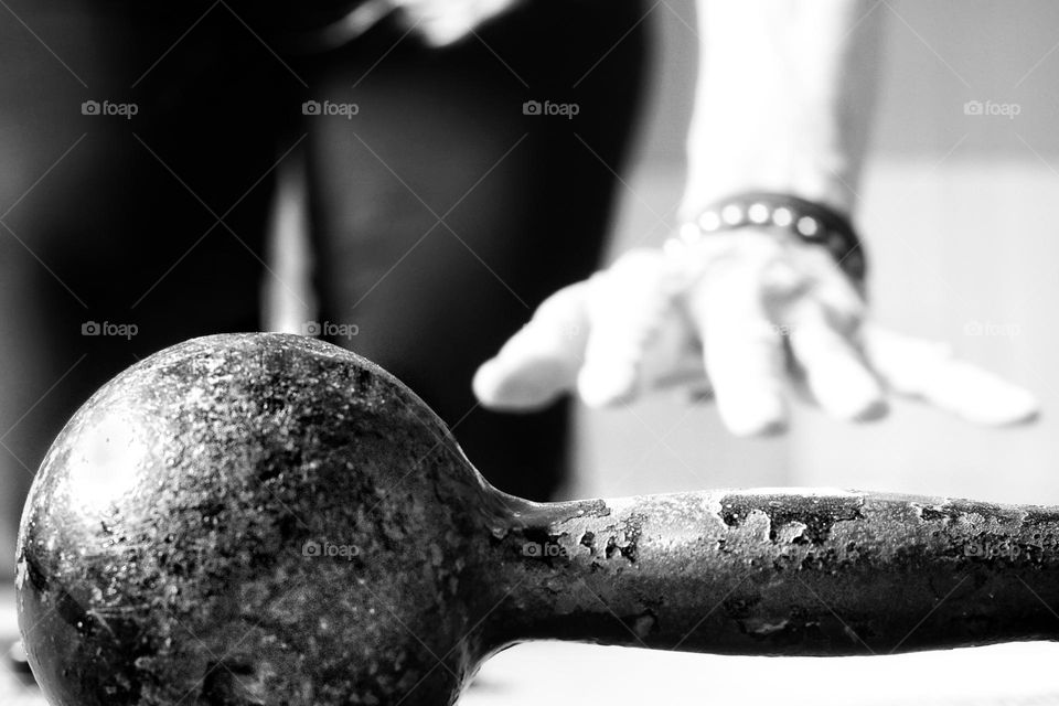 Close-up of a woman's hand grabbing a dumbbell