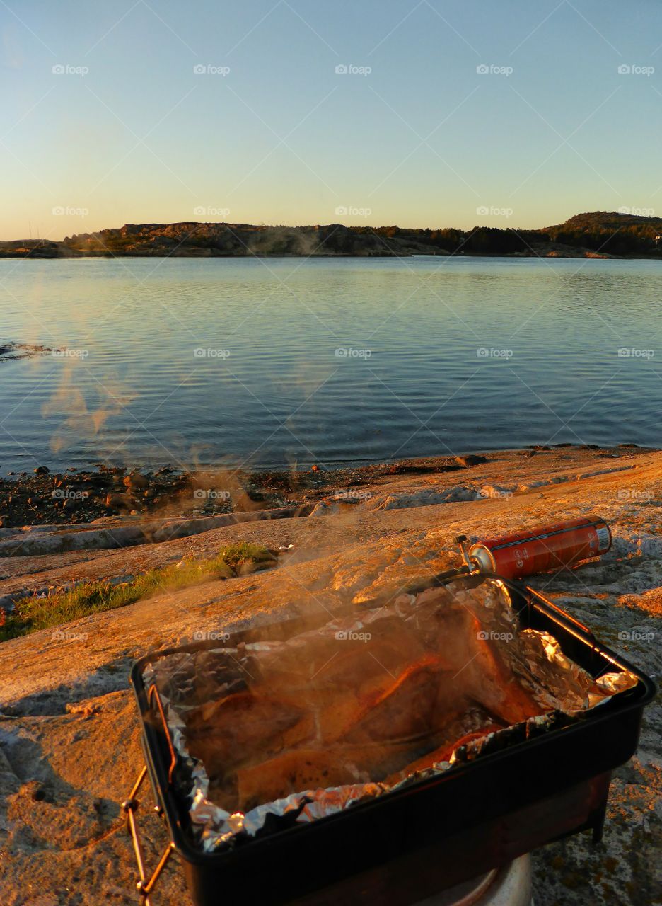 Close-up of barbecue grill near sea