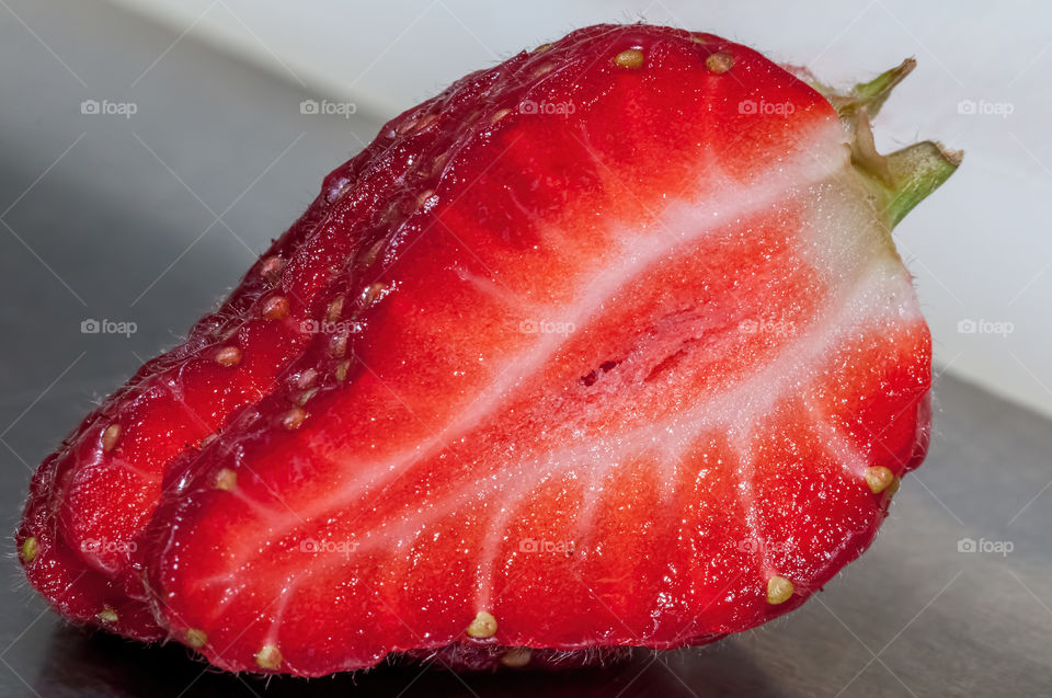 Single sliced strawberry featuring detailed internal and external structures.