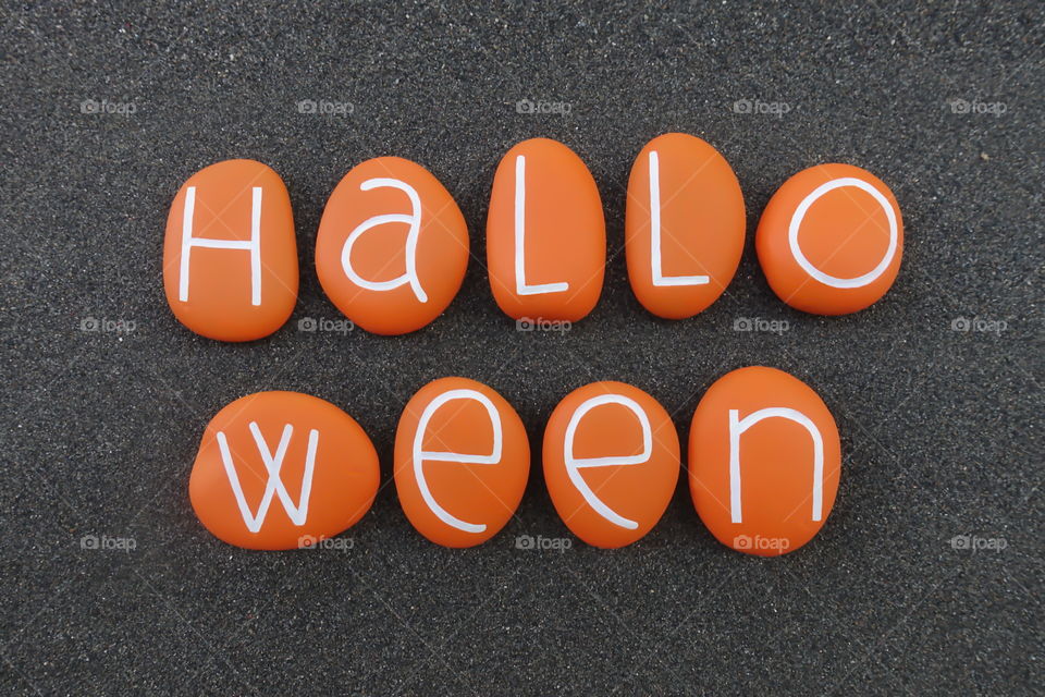 Halloween text with orange painted stones