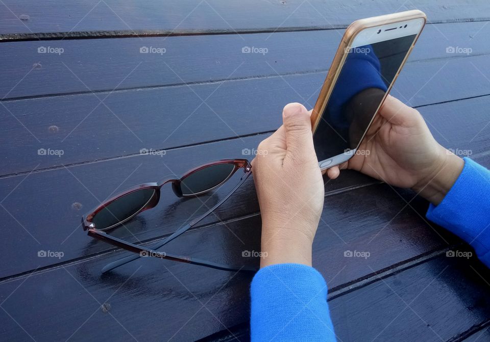 The hand of a woman using a mobile phone
