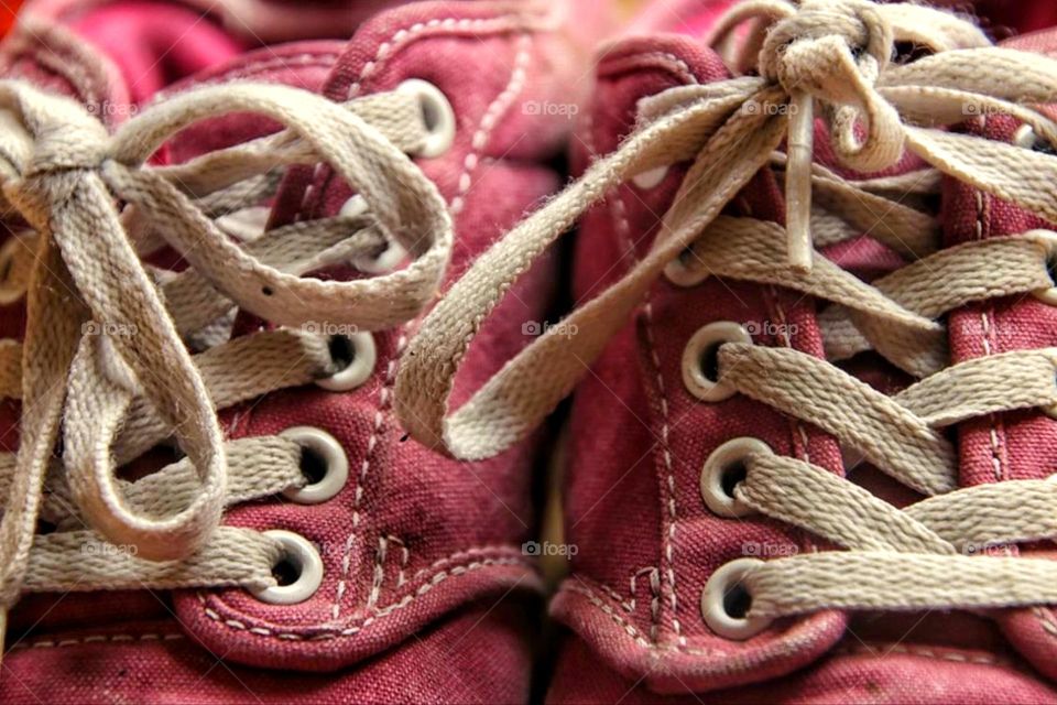 Close-up of two pink sneakers with white laces