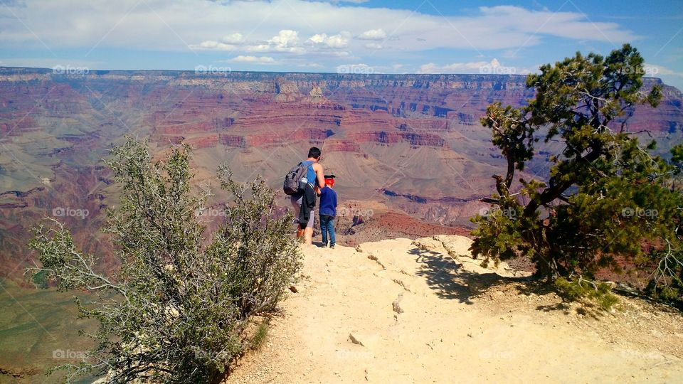 Looking over the Edge. Father and son looking over the edge of the Grand Canyon