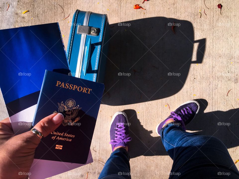 Standing with passport in hand 
