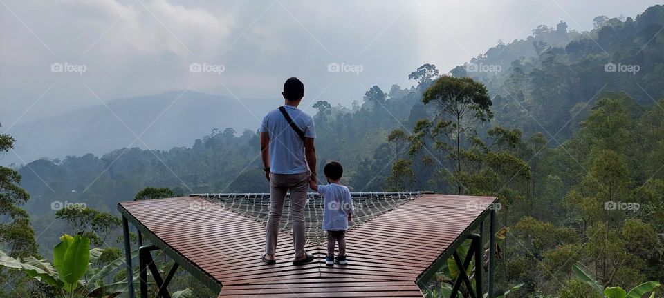 Father and son looking forward