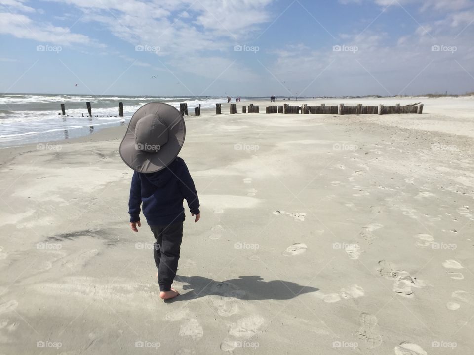 Child walking on the beach.