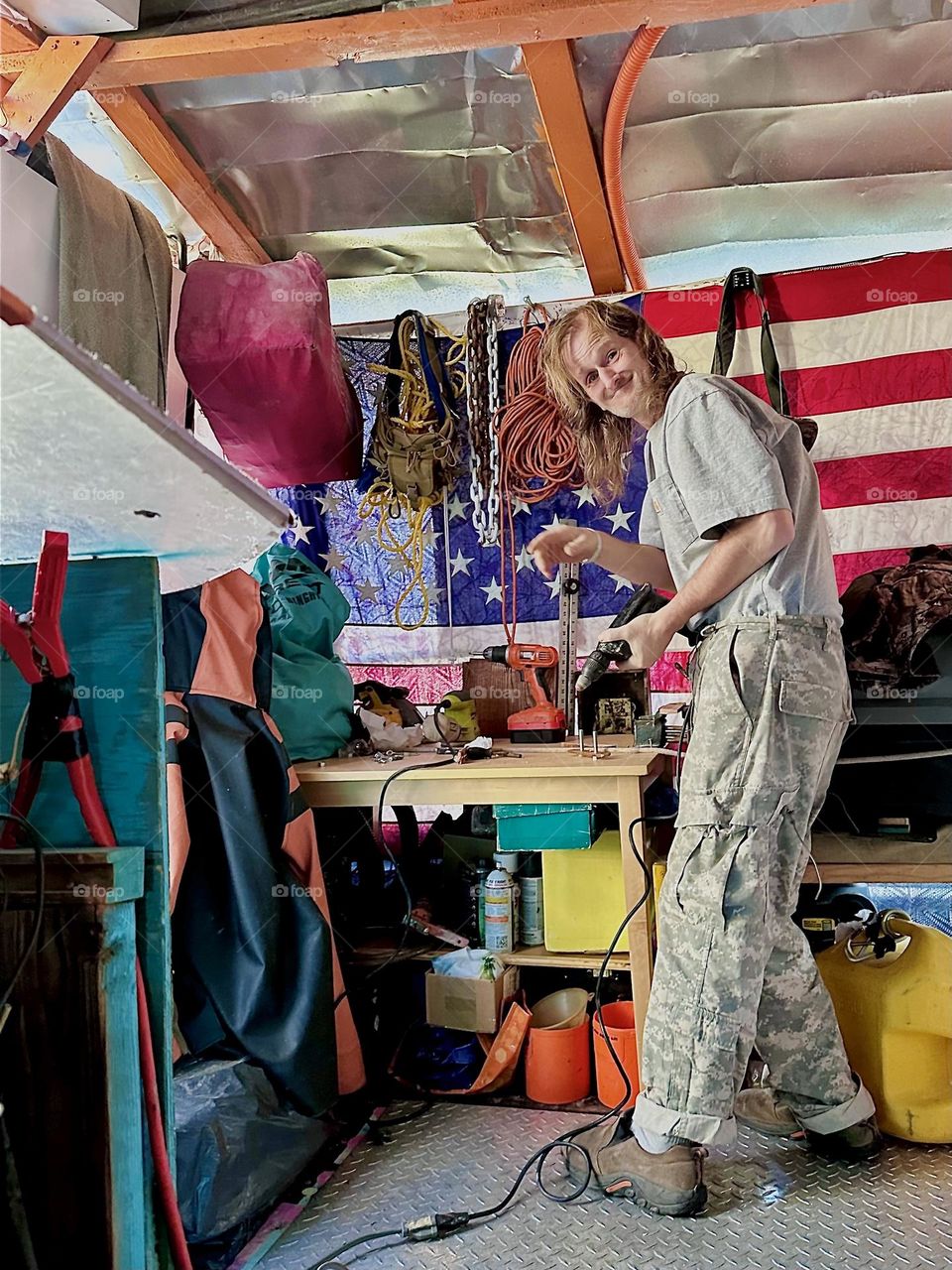 This is „Timothy Trespas“, my partner and significant other aboard „Salvation“, the boat at „Newtown Creek“ in LIC, Queens we call home working on various improvements around the house. The flag shows that we’re patriotic. 2023. Hypnotic Productions