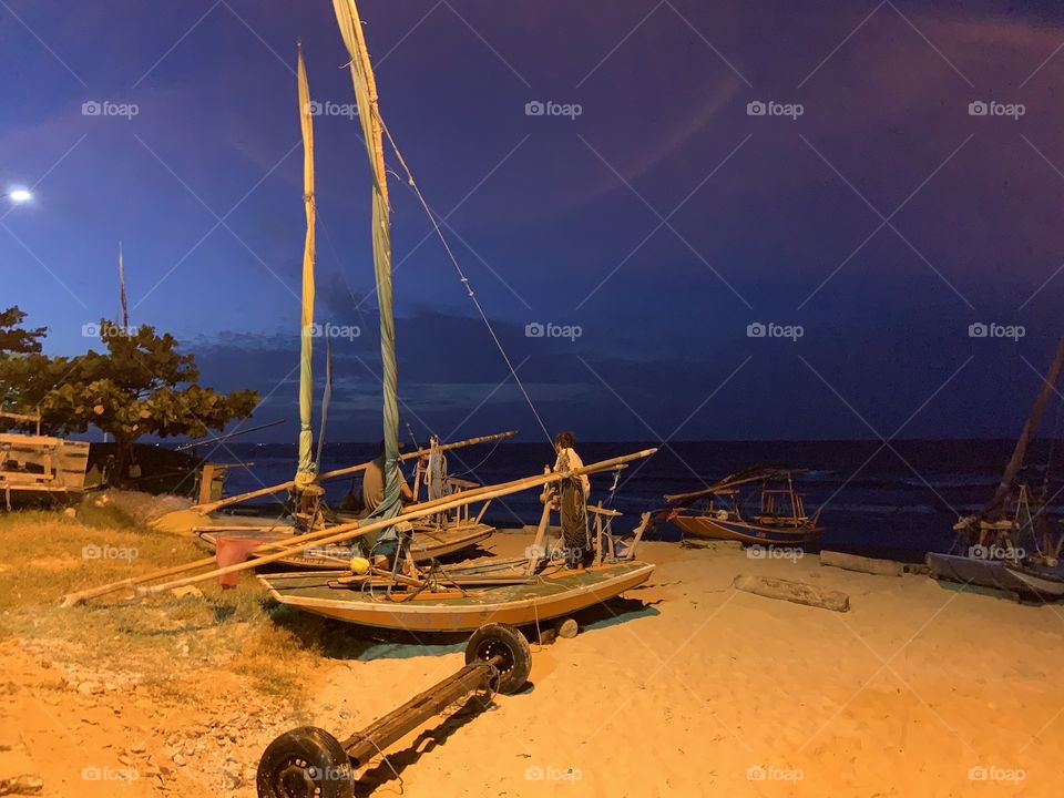 Fischer boat in the beach in the night 
