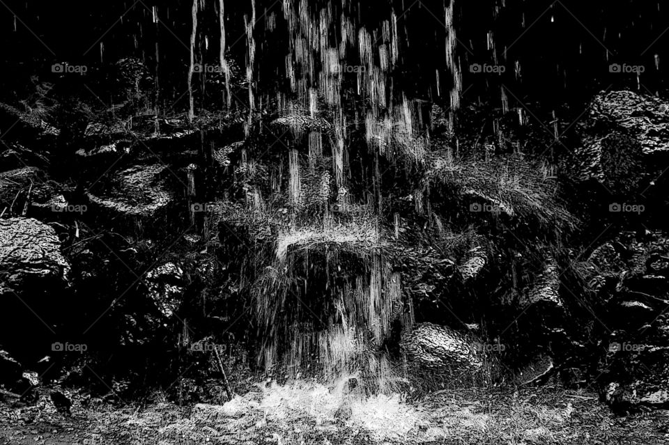 A black & white abstract taken at the foot of a waterfall. Played with manual settings on my camera & used desktop tools to bring out a myriad of textures on the rocks, plants & splashing water. So much fun!