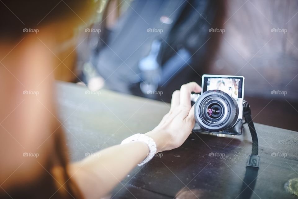 A girl is taking selfie using her camera