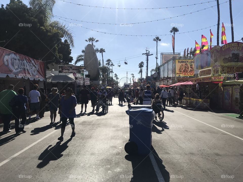 Along the main lane facing the midway, the crowd looks for food to eat at the San Diego County Fair on July 2, 2018.