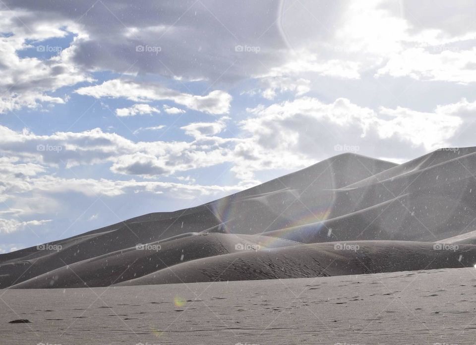 A light rain sparkling down upon the sands of Great sand dunes national park. 