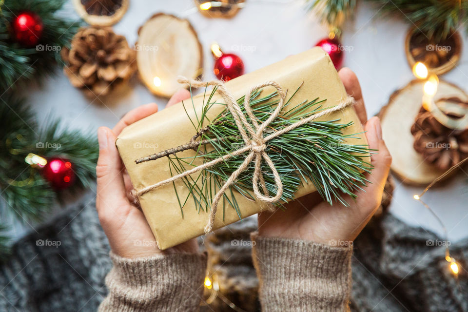 Female hands holding wrapped gift box