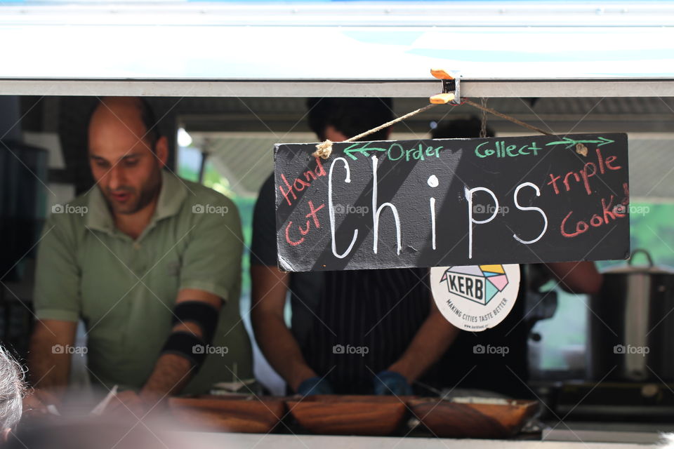 A street food market in Kings Cross, London called The Kerb. A food stall selling chips.
