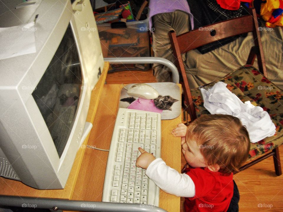 Toddler Playing On A Computer
