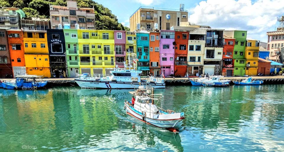 From A to B: a fishing boat leaved the beautiful fishing port to go fishing on the sea.