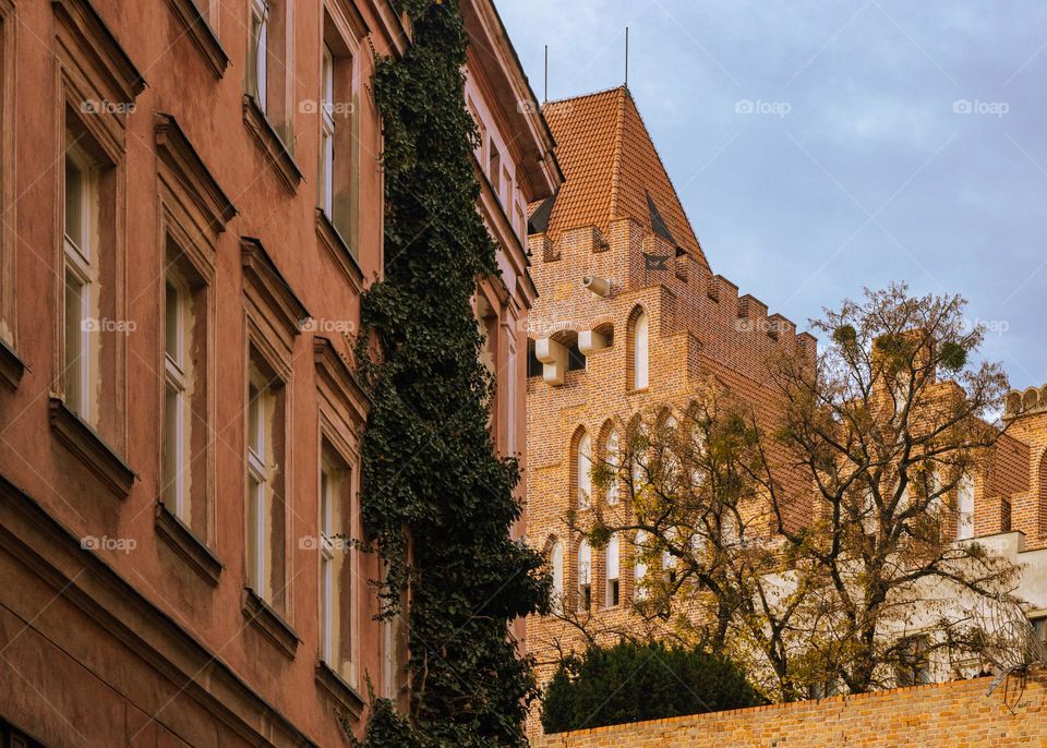 a fragment of the castle tower and a tenement house in the old town of Poznan