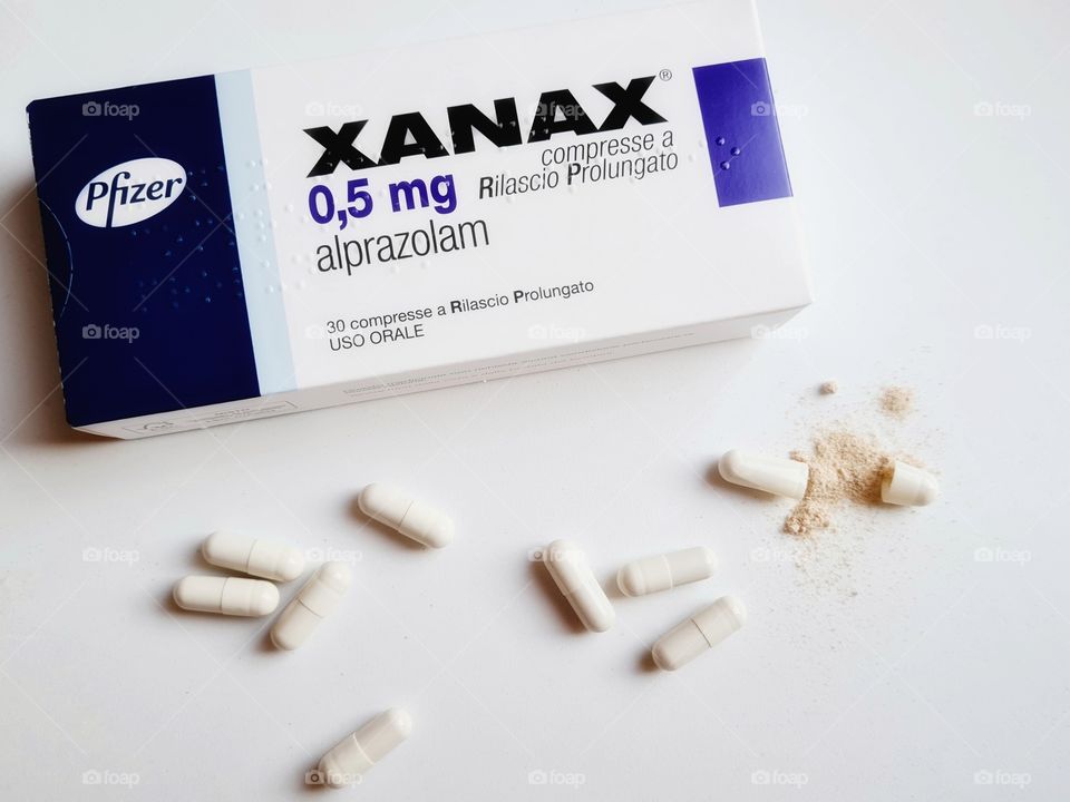 box of xanax drug and capsules