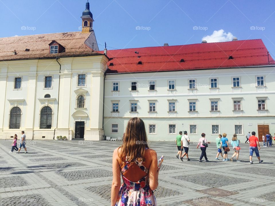 back of woman looking at buildings