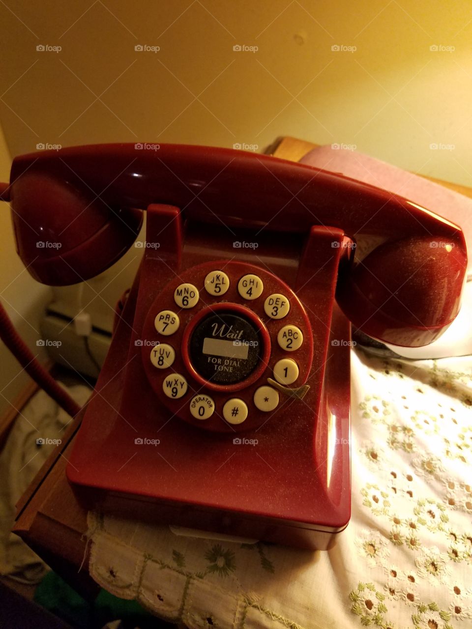 red retro phone on nightstand