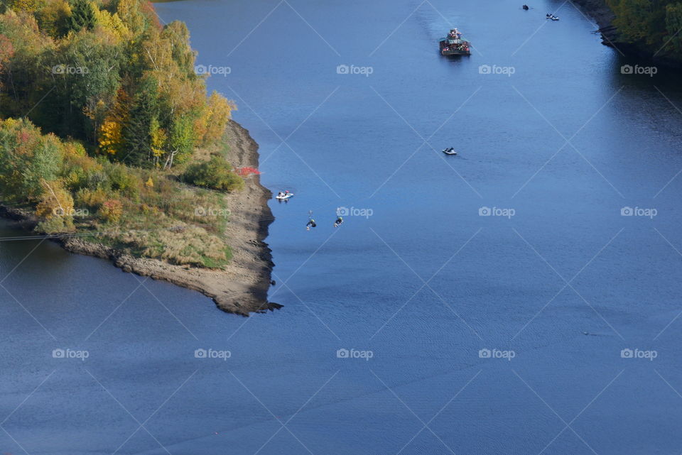 view from a suspension bridge on a reservoir and the autumn landscape
