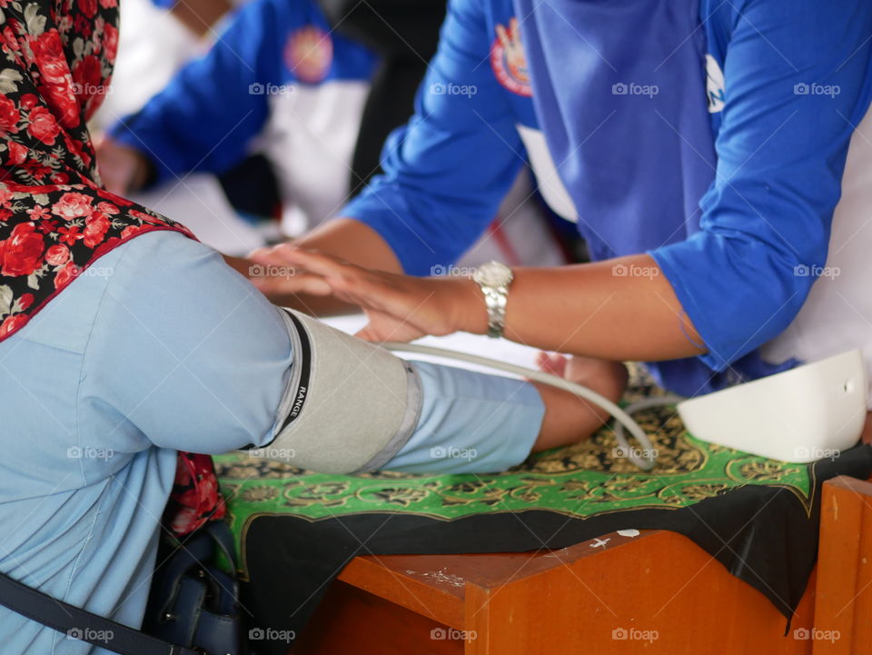 Tarakan/Indonesia-09172019: A family planning field officer was checking acceptor blood pressure before using contraceptives on September 17, 2019 in Tarakan, Indonesia