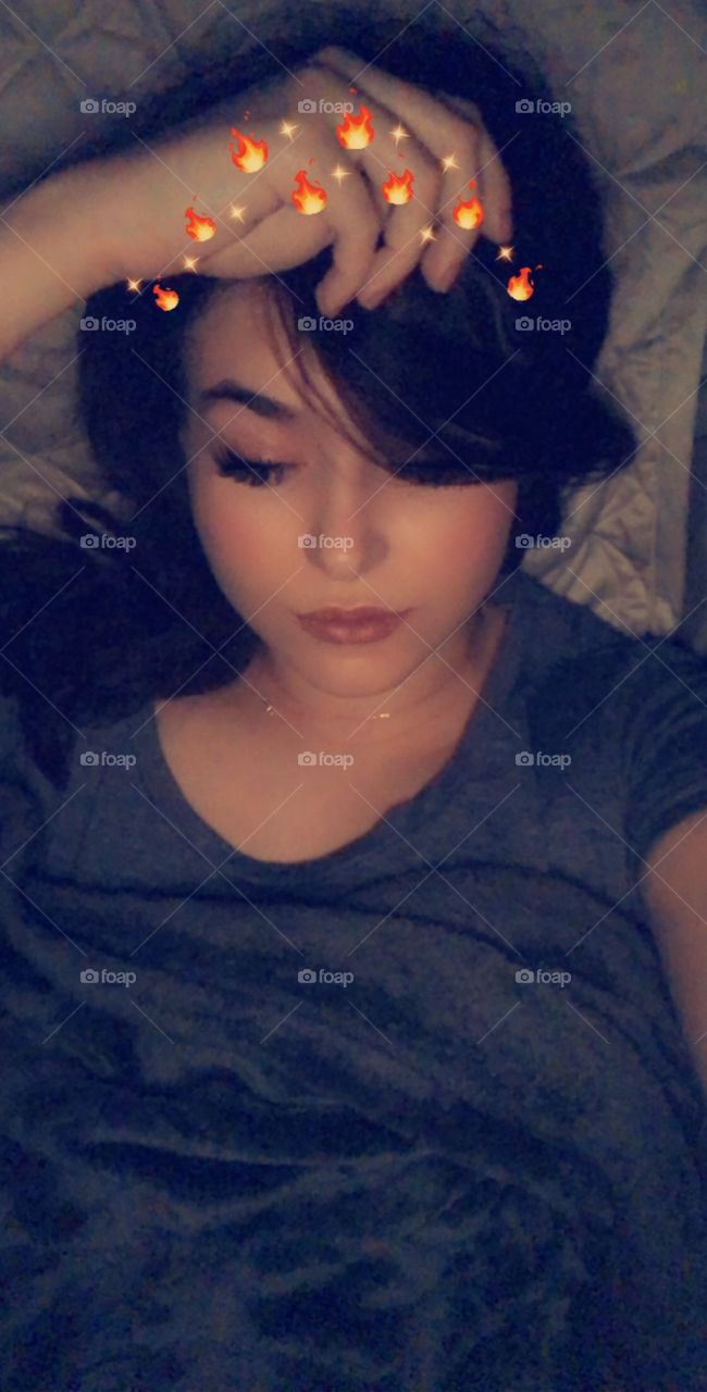 Sleepy time selfie. Brunette girl takes bedtime selfie with a Snapchat filter in bed at like 4am. 