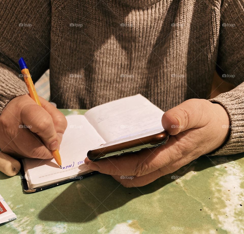 People writing on notebook