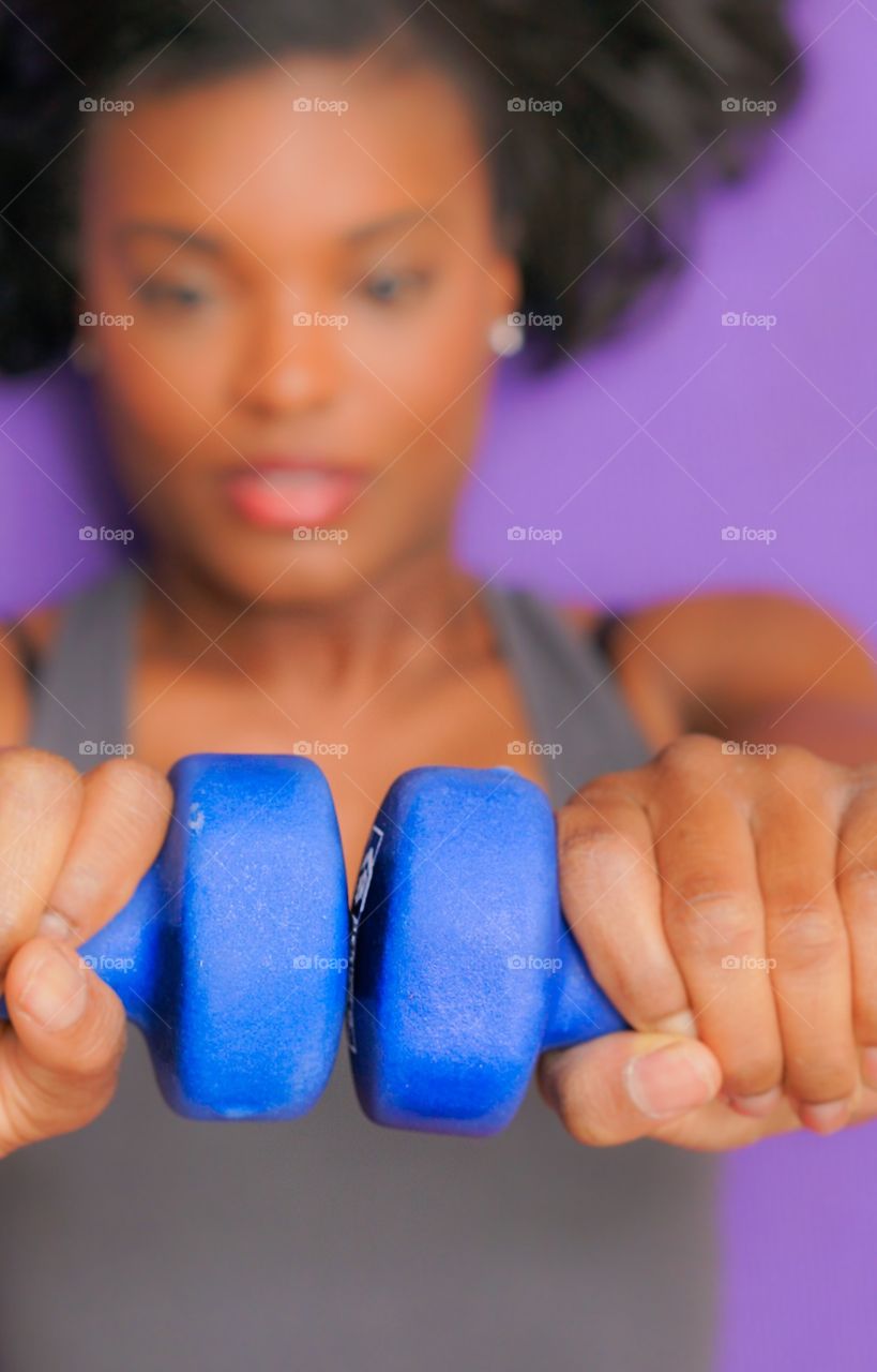 Close-up of a woman's hand exercising with dumbbells