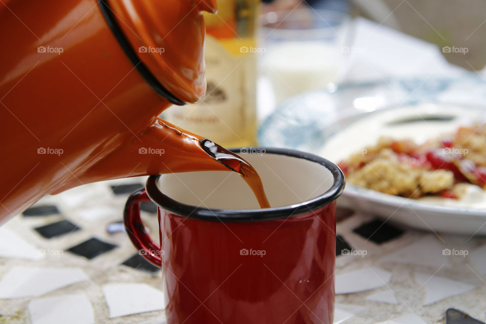 Pouring coffee in mug
