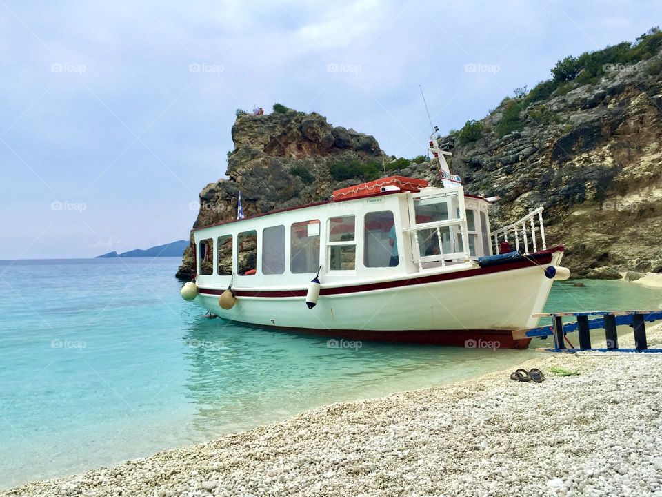 Empty tourist boat on the beach shore during summer 