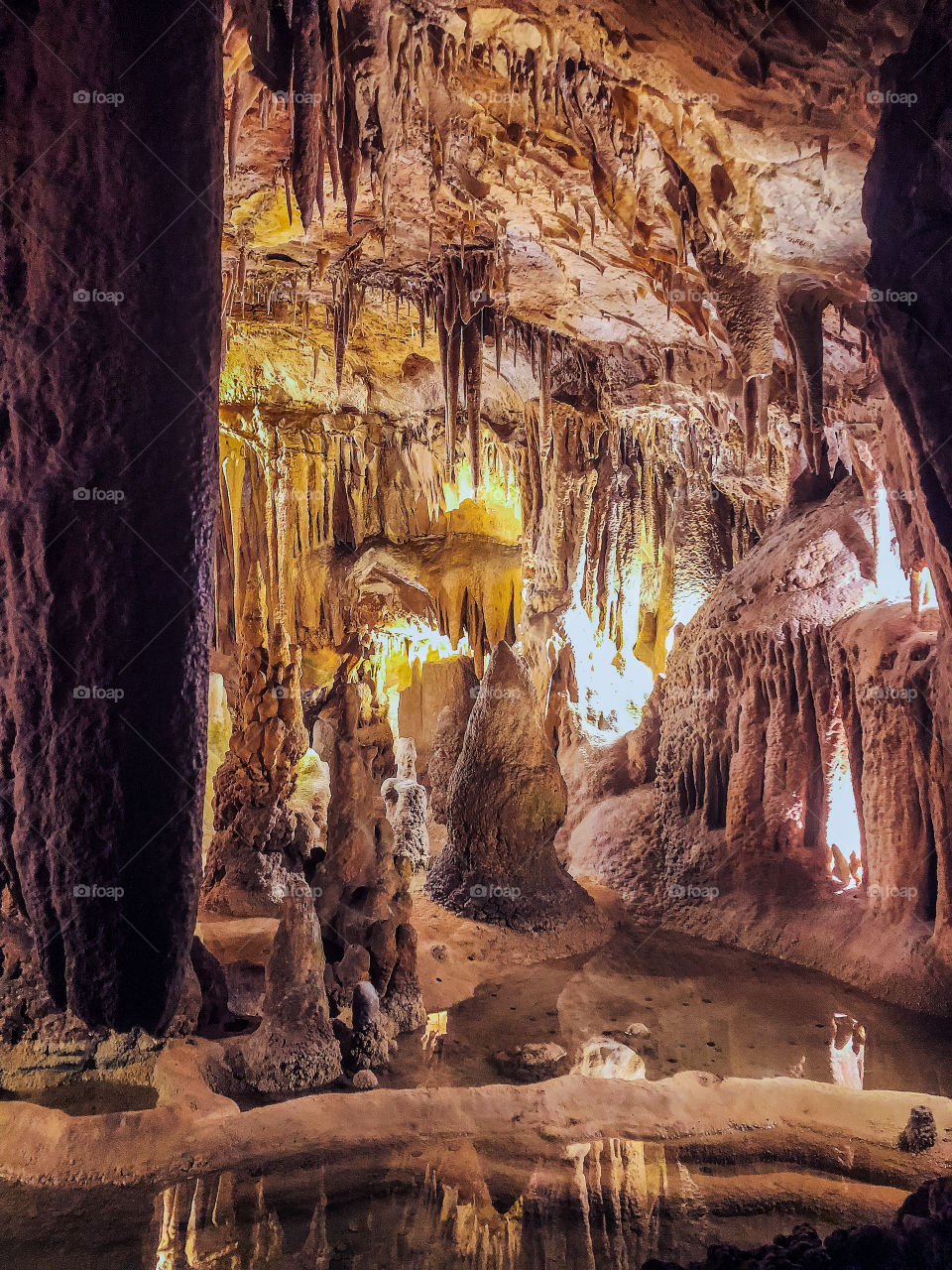 Pools of water below the stalactites at Grutas de Alvados - Central Portugal- 2019